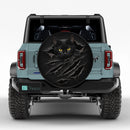 Black Cat Tearing Through Car Spare Tire Cover